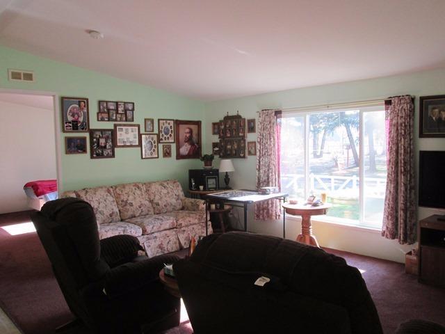 5264 Holland Loop Road Cave Junction, OR 97523 - Photo 4 of 32 a living room with furniture and a flat screen tv