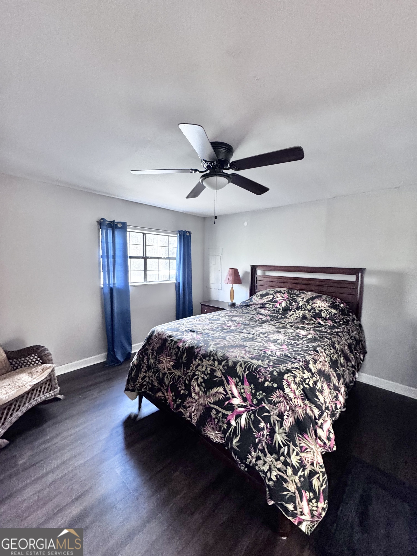 1427 & 1427c Magnolia Road Reidsville, GA 30453 - Photo 12 of 18 a bed sitting in a bedroom next to a window and a chandelier
