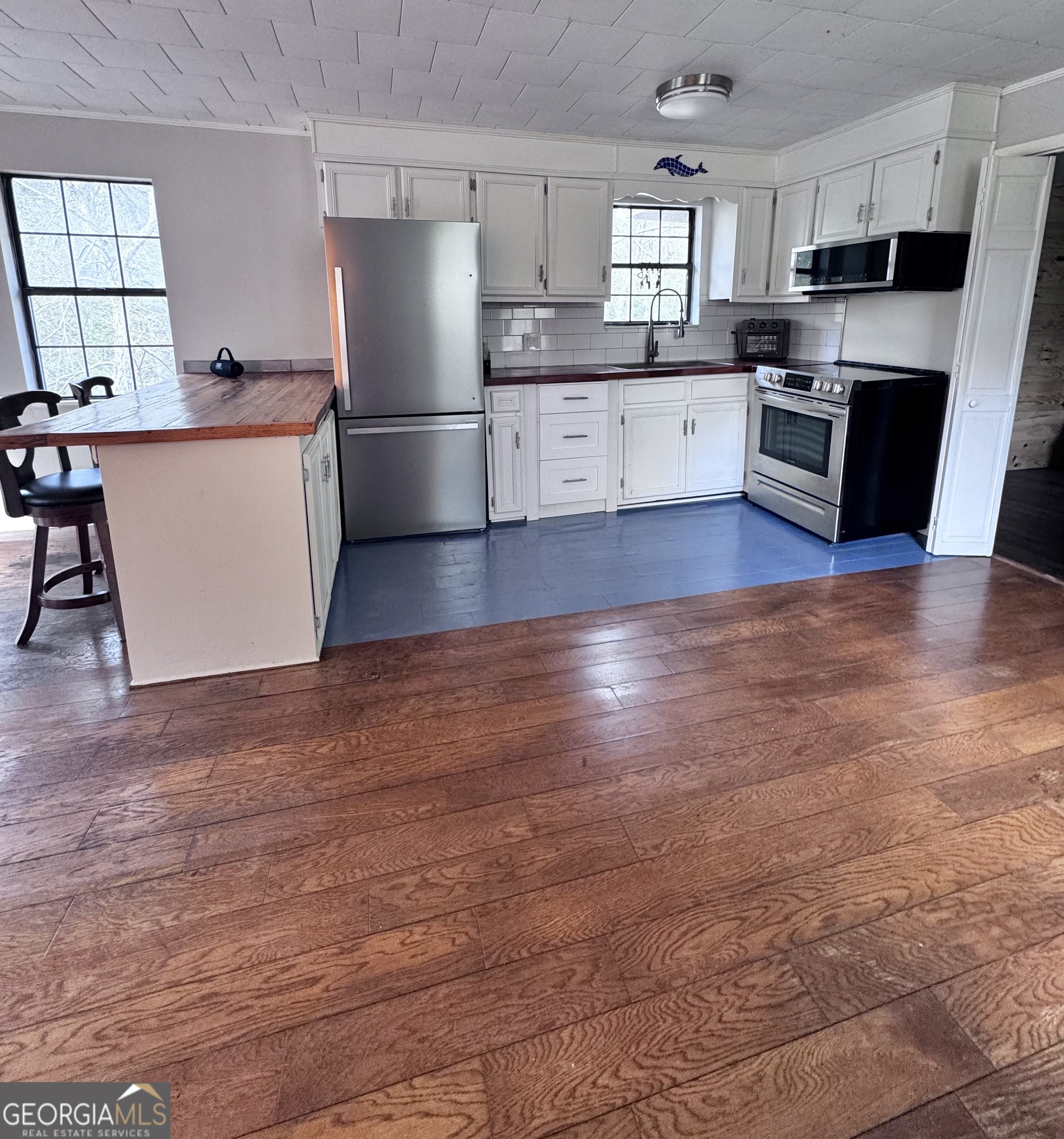 1427 & 1427c Magnolia Road Reidsville, GA 30453 - Photo 14 of 18 a large kitchen with stainless steel appliances granite countertop a large counter top stove a sink dishwasher and a refrigerator