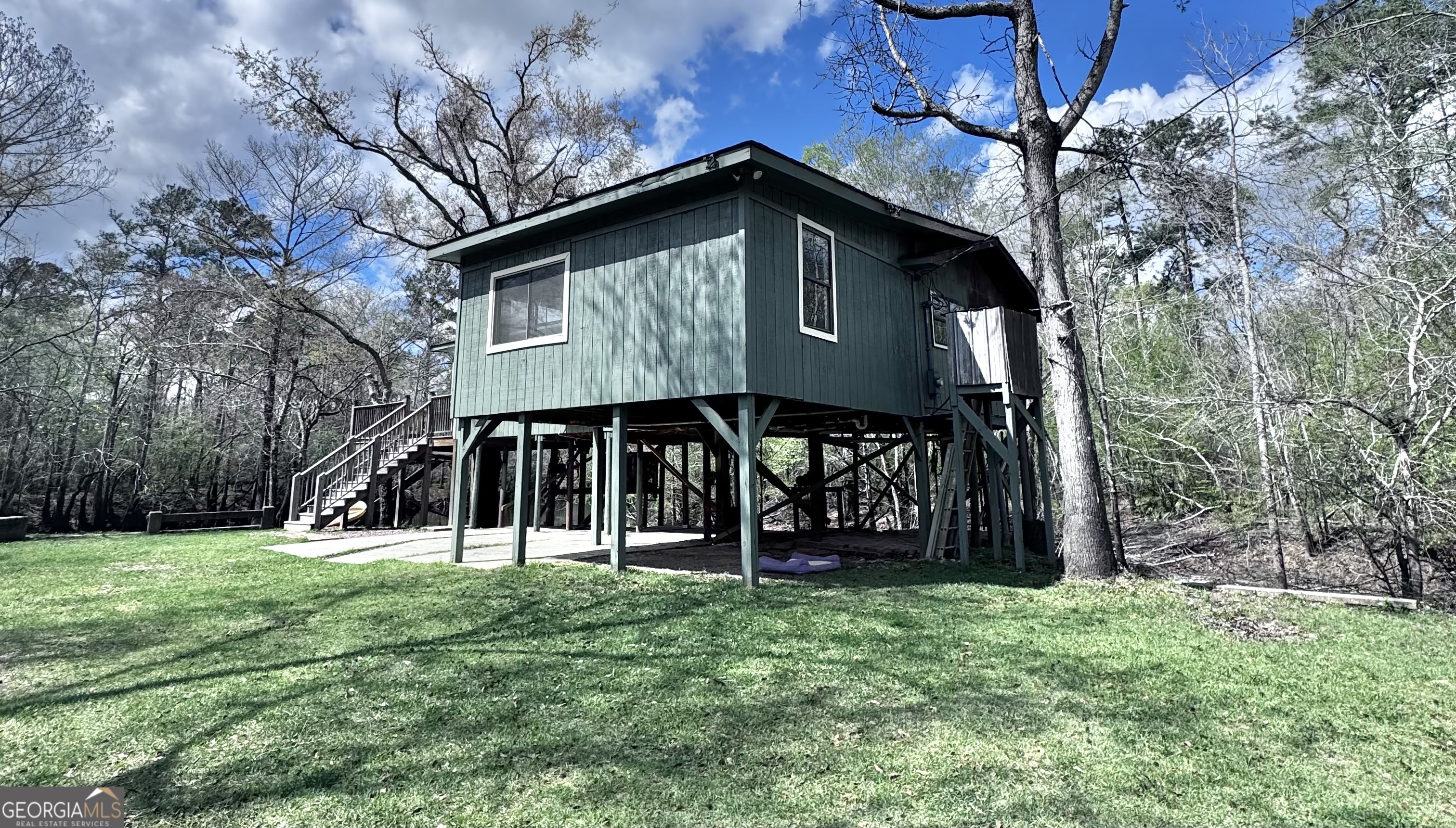 1427 & 1427c Magnolia Road Reidsville, GA 30453 - Photo 3 of 18 a view of a wooden house with a big yard