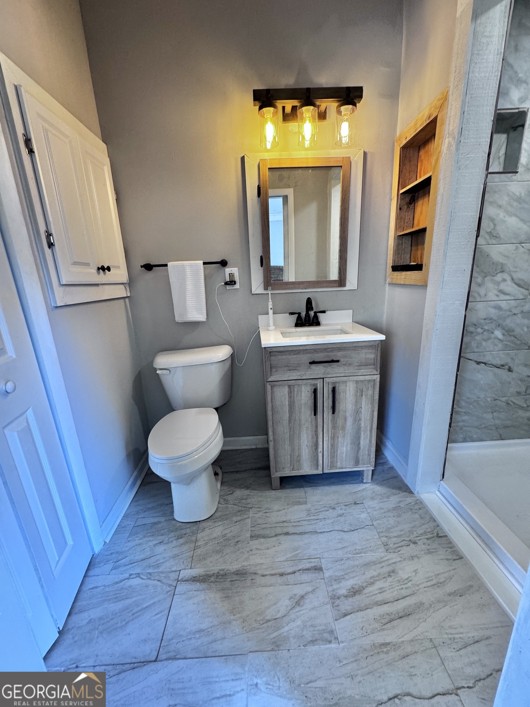 1427 & 1427c Magnolia Road Reidsville, GA 30453 - Photo 9 of 18 a bathroom with a toilet sink and mirror