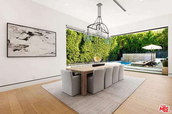 a kitchen with kitchen island granite countertop a sink counter top space and a view of living room