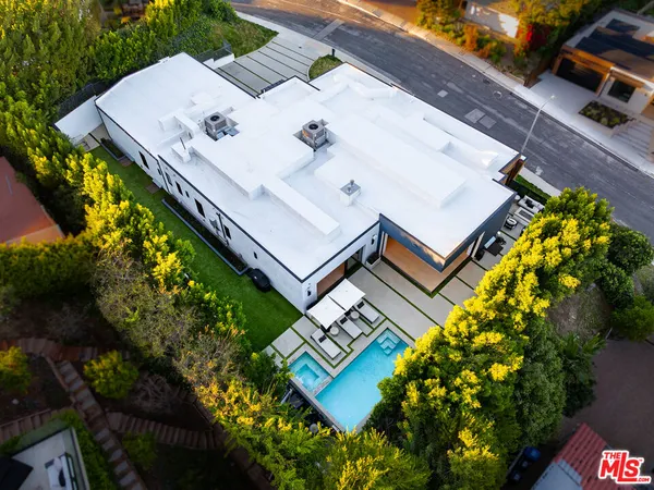an aerial view of a house with a yard