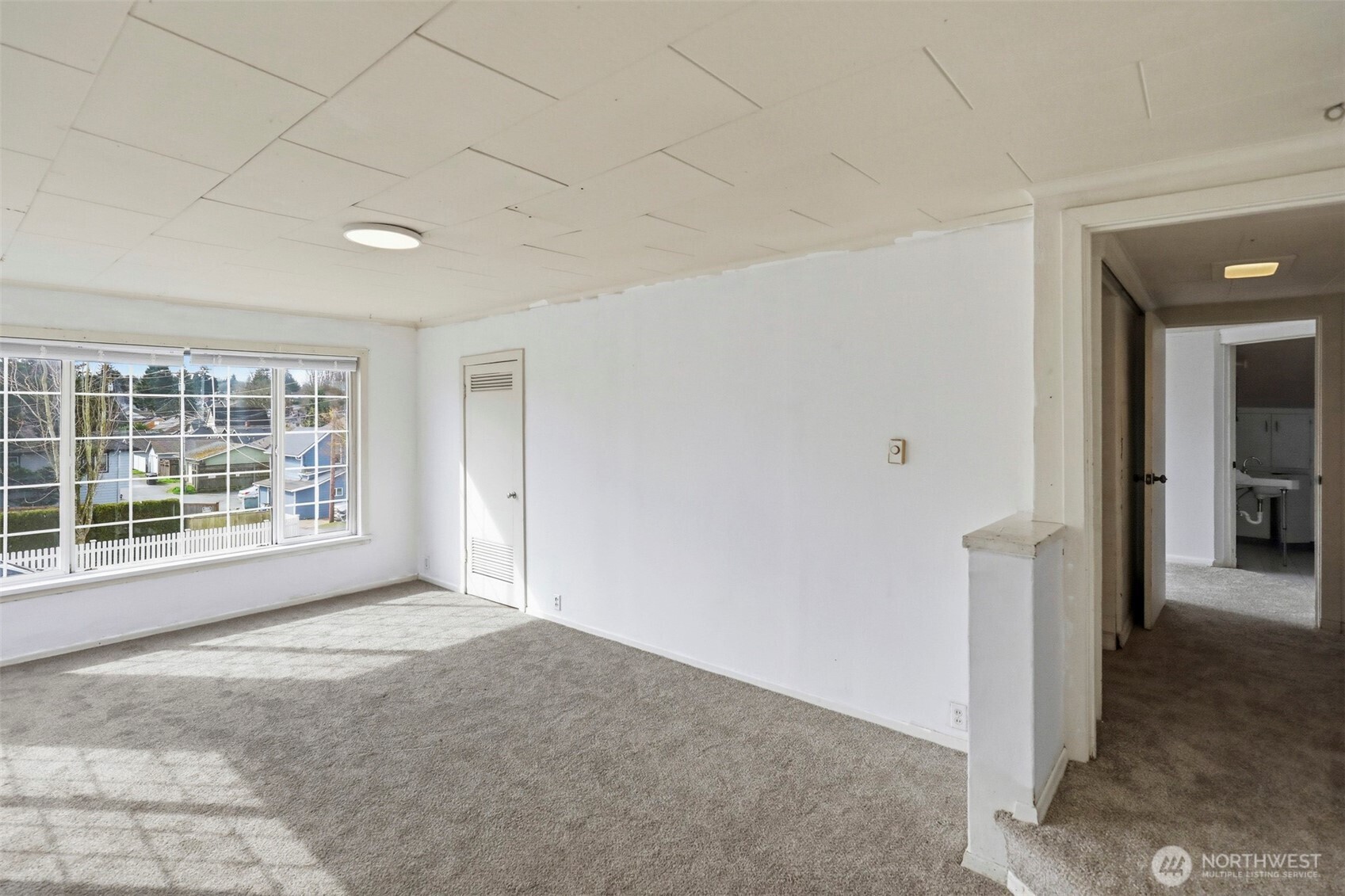 1817 34th Street Everett, WA 98201 - Photo 4 of 19 a view of empty room with wooden floor and fan