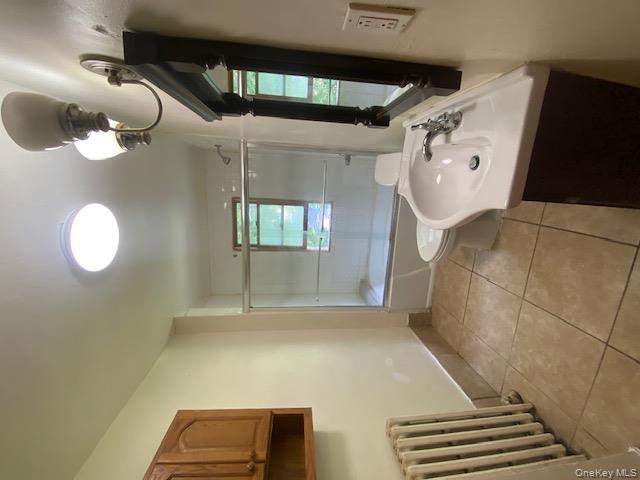 72 North Liberty Drive, Unit 2 Stony Point, NY 10980 - Photo 3 of 12 a bathroom with a sink a light fixture and a mirror
