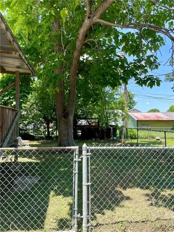 a front view of a house with a tree