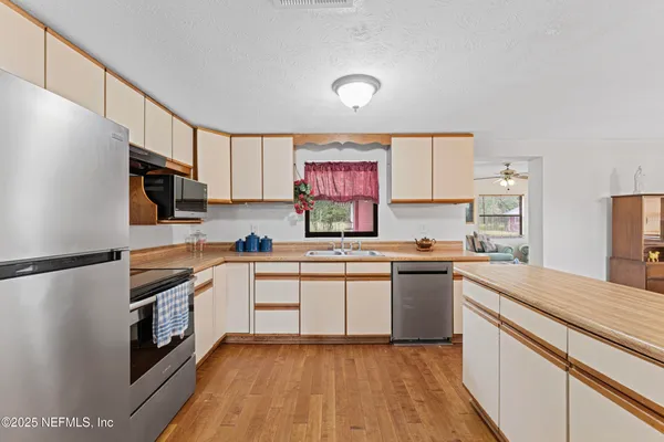 a kitchen with a sink stove and refrigerator