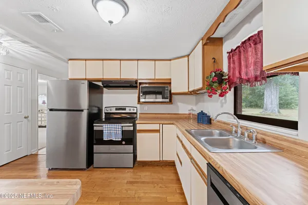 a kitchen with stainless steel appliances granite countertop a refrigerator and a sink