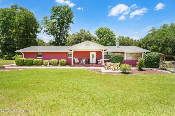 a front view of house with yard and outdoor seating