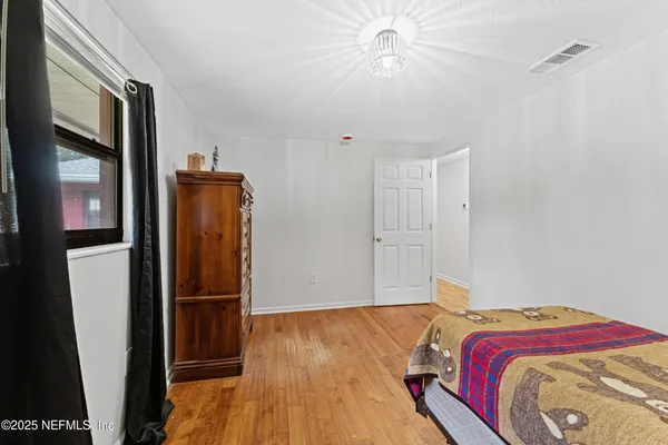 a bedroom with a bed and a mirror