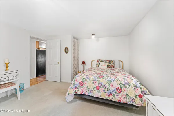 a bedroom with a bed and a table