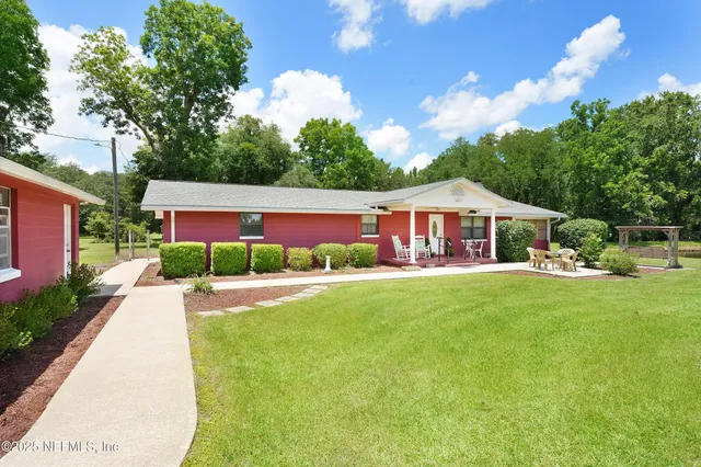 a front view of house with yard and green space