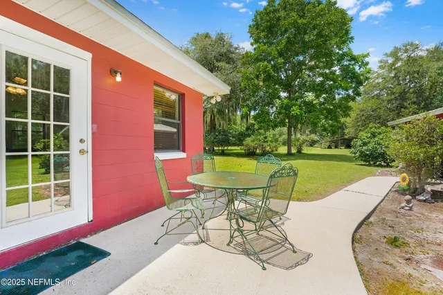 a view of a backyard with furniture and backyard