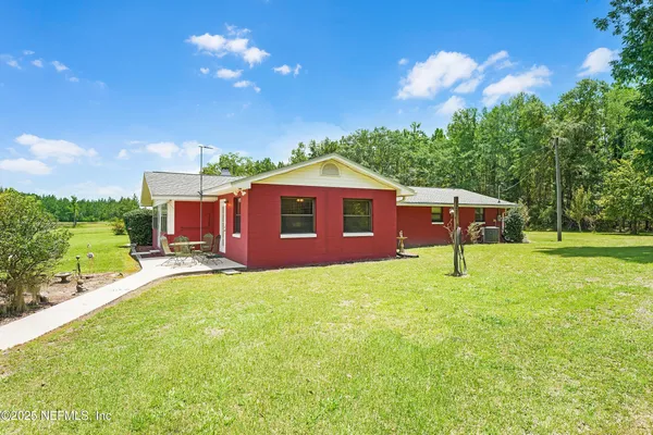 a front view of house with yard entertaining space and outdoor seating