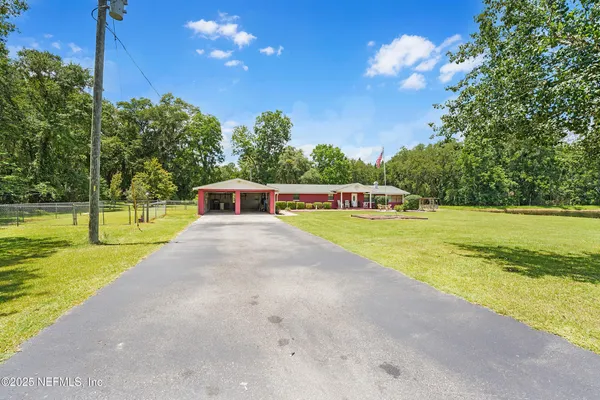 a view of yard with swimming pool and green space