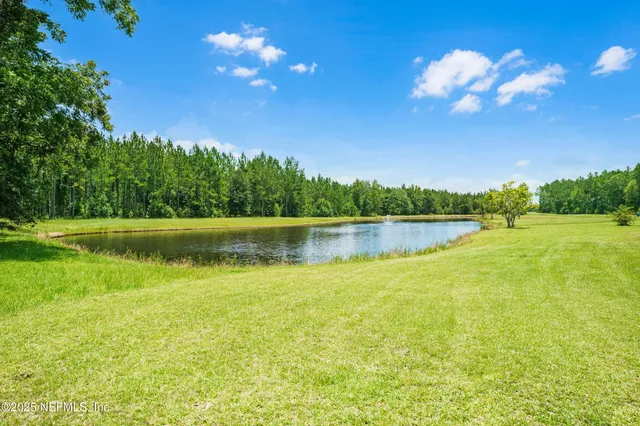 a view of a backyard with swimming pool