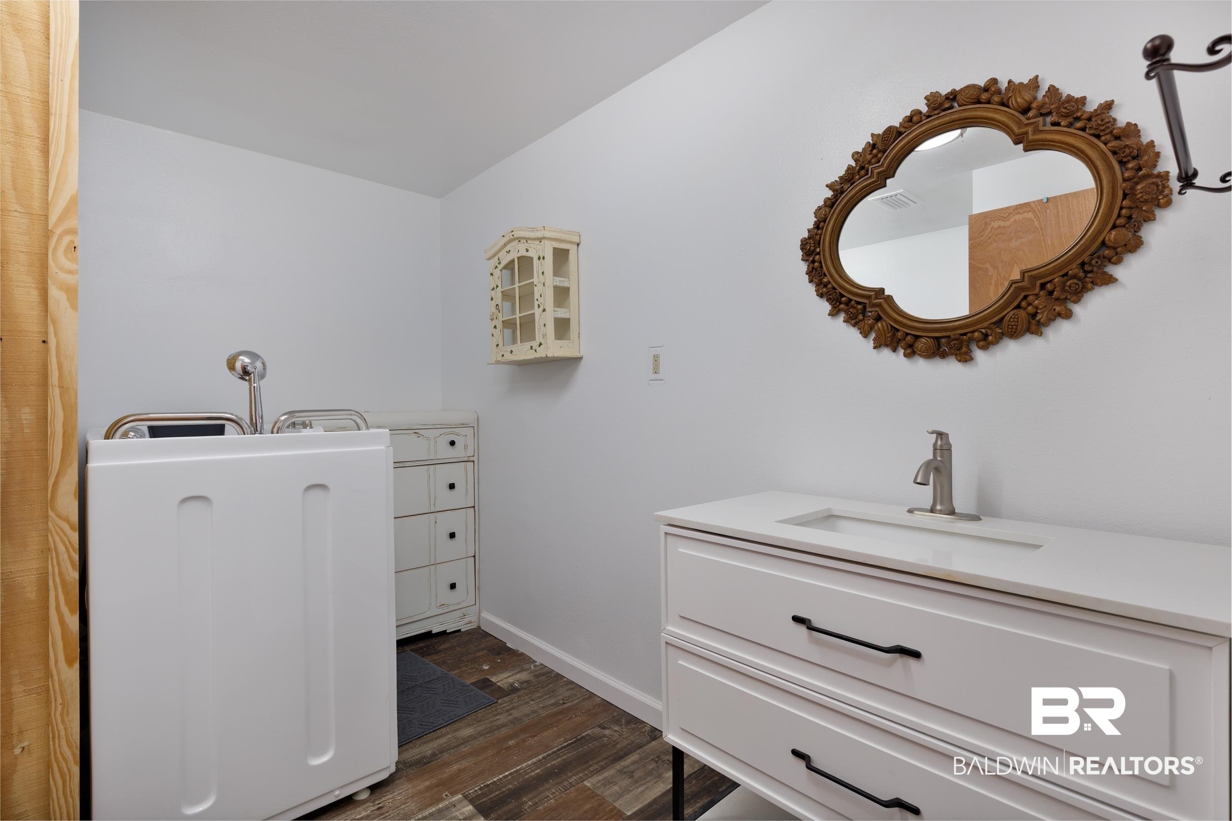 6725 Upper Creek Road Flomaton, AL 36441 - Photo 58 of 61 Bathroom featuring wood finished floors, baseboards, vanity, and lofted ceiling