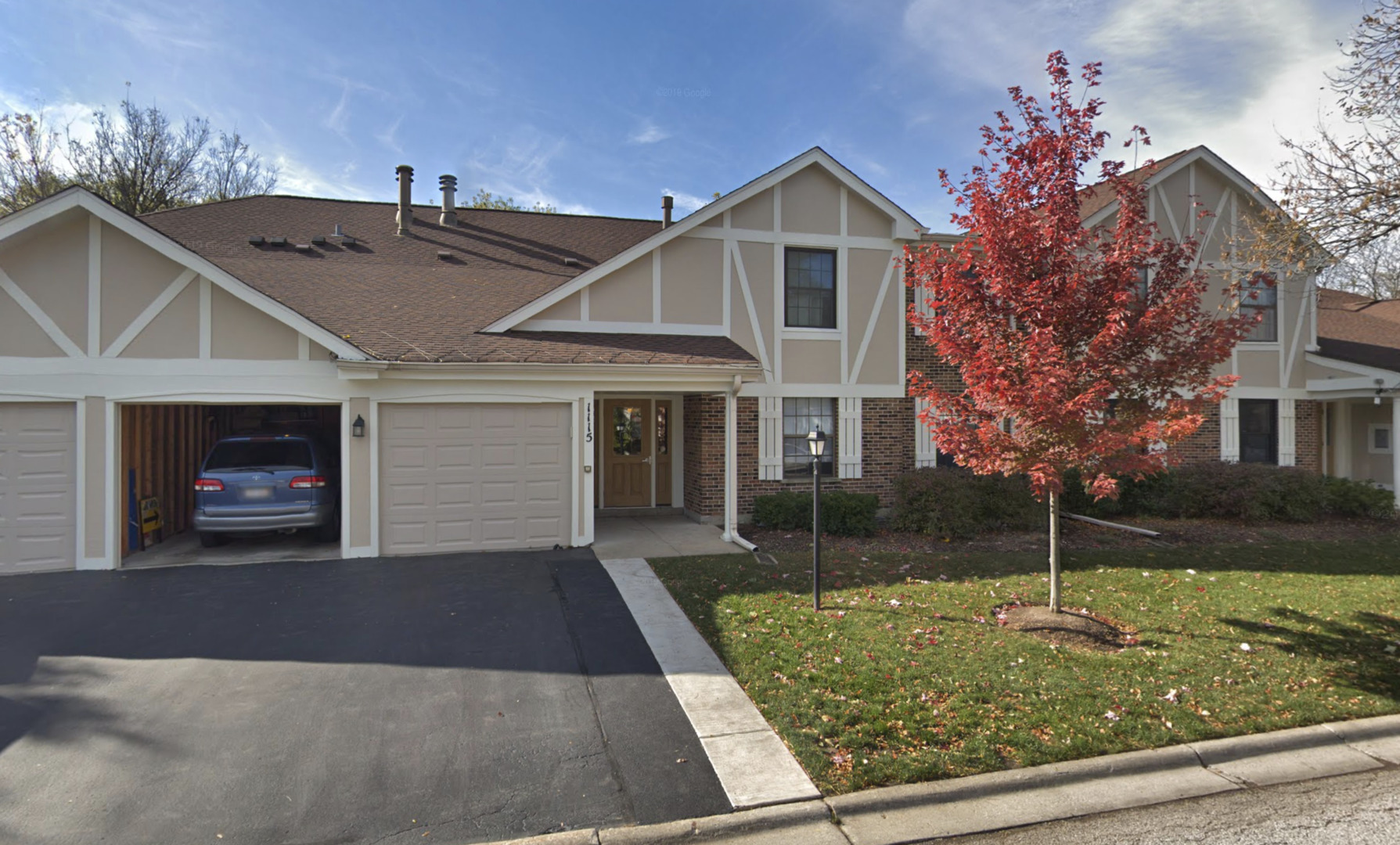 1115 Scanlon Drive, Unit B1 Wheeling, IL 60090 - Photo 1 of 12 a view of a house with a yard and garage