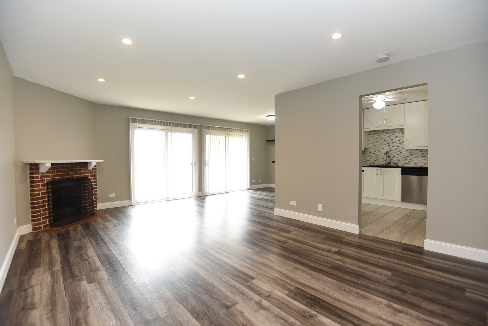 1115 Scanlon Drive, Unit B1 Wheeling, IL 60090 - Photo 2 of 12 a view of an empty room with wooden floor and a window