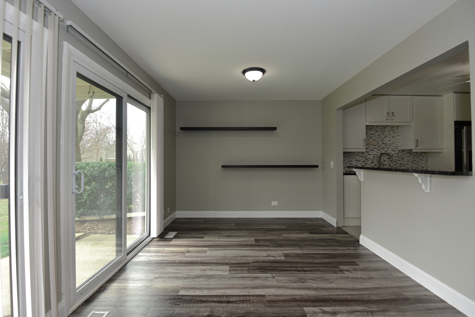 1115 Scanlon Drive, Unit B1 Wheeling, IL 60090 - Photo 5 of 12 a view of room with window and wooden floor