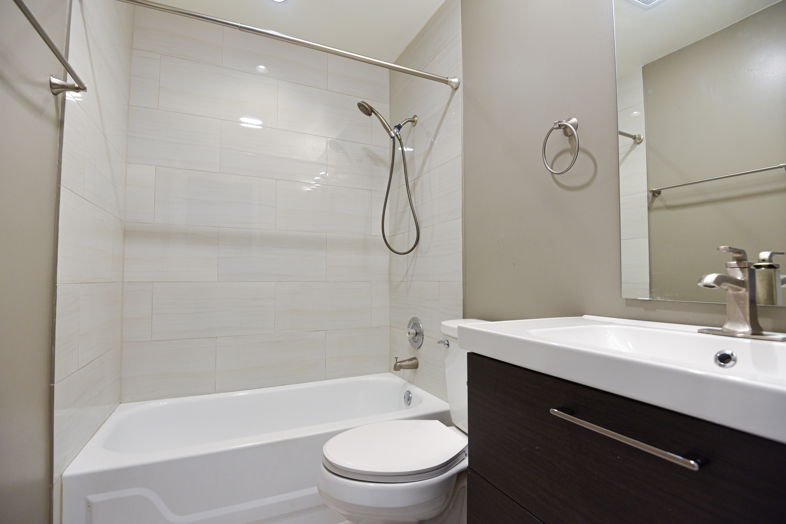 1115 Scanlon Drive, Unit B1 Wheeling, IL 60090 - Photo 6 of 12 a bathroom with a sink a toilet and shower