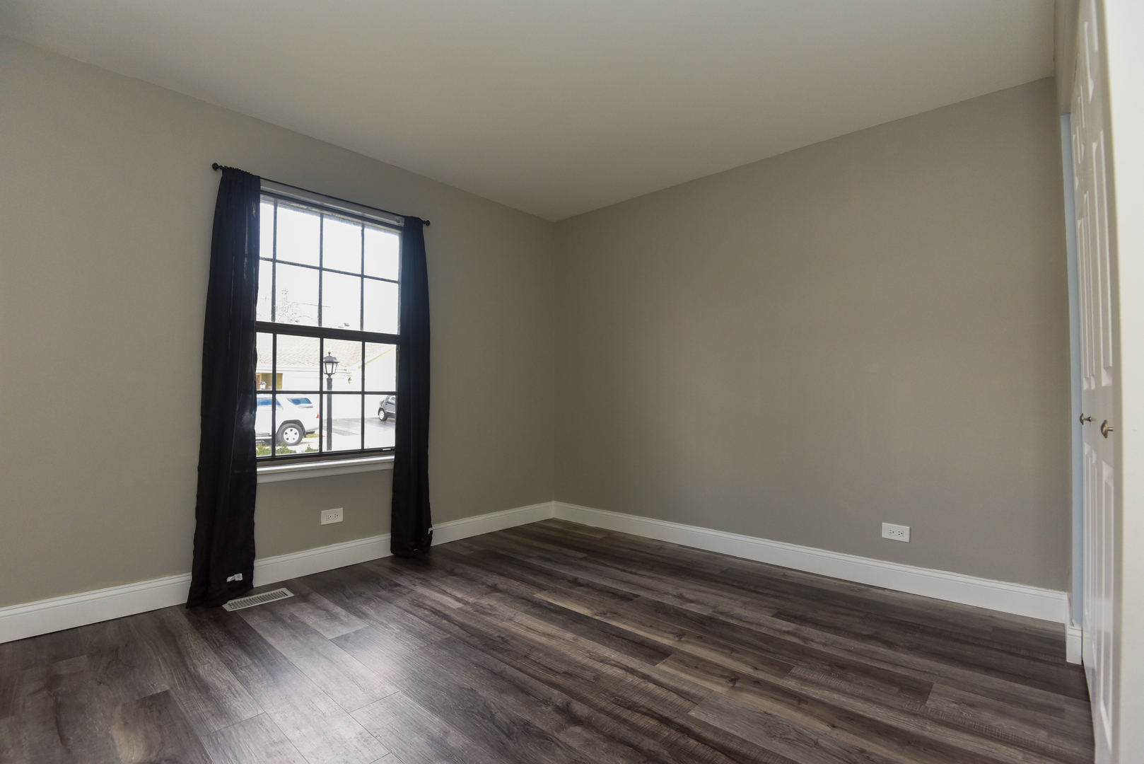 1115 Scanlon Drive, Unit B1 Wheeling, IL 60090 - Photo 9 of 12 an empty room with wooden floor and windows