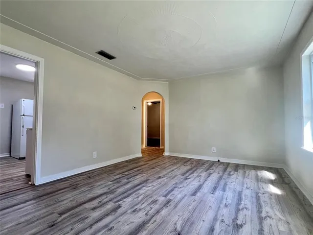 a view of a room with wooden floor and white walls