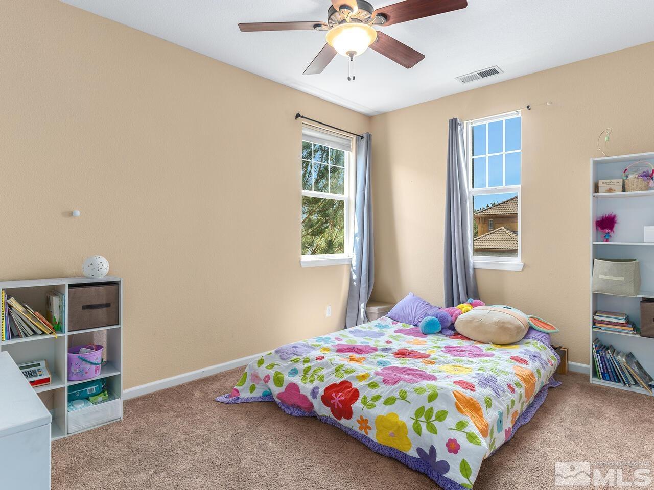 515 Little Sorrel Court Reno, NV 89521 - Photo 17 of 26 a bedroom with a bed and a chandelier