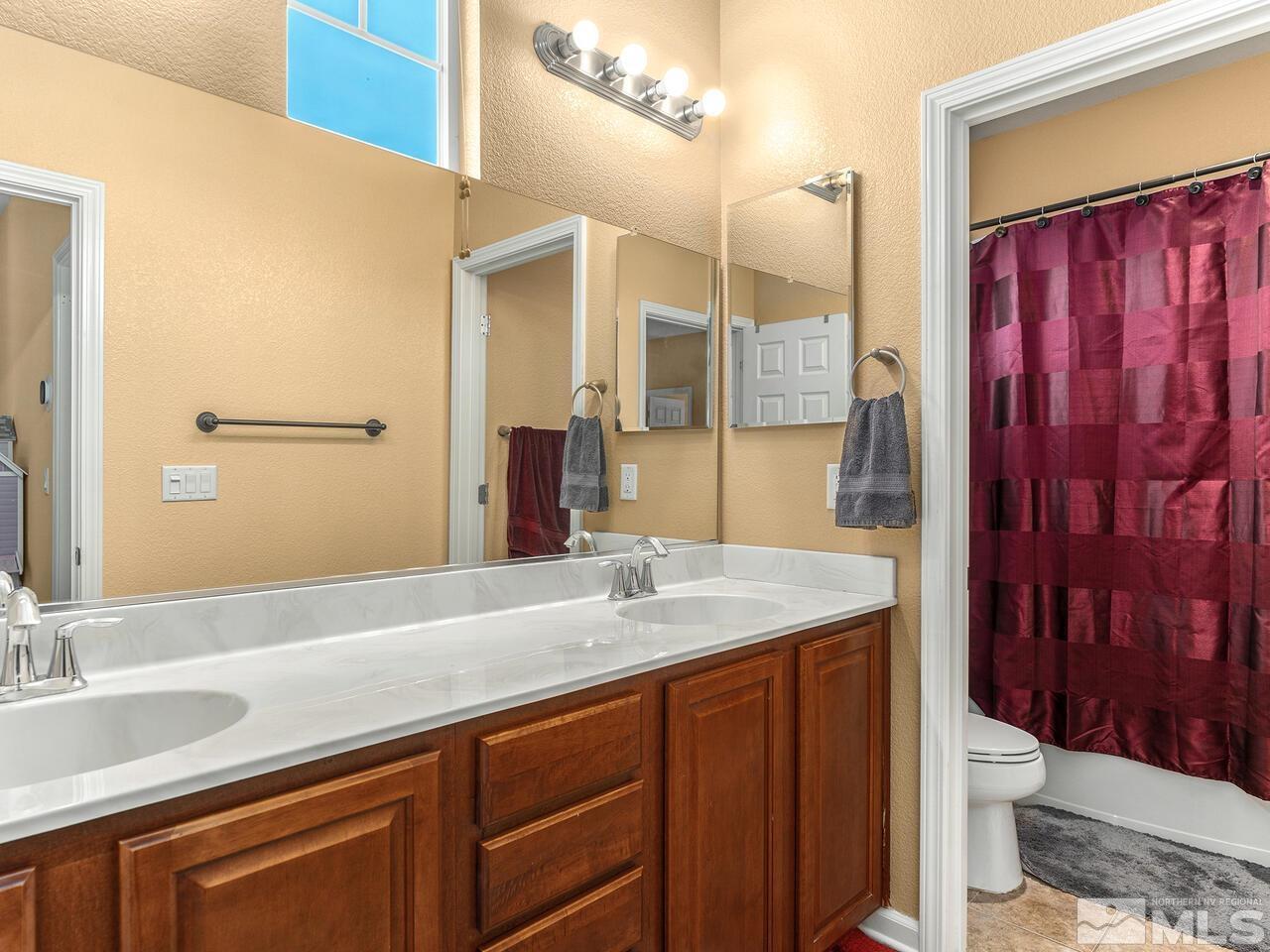 515 Little Sorrel Court Reno, NV 89521 - Photo 20 of 26 a bathroom with a sink vanity granite and toilet