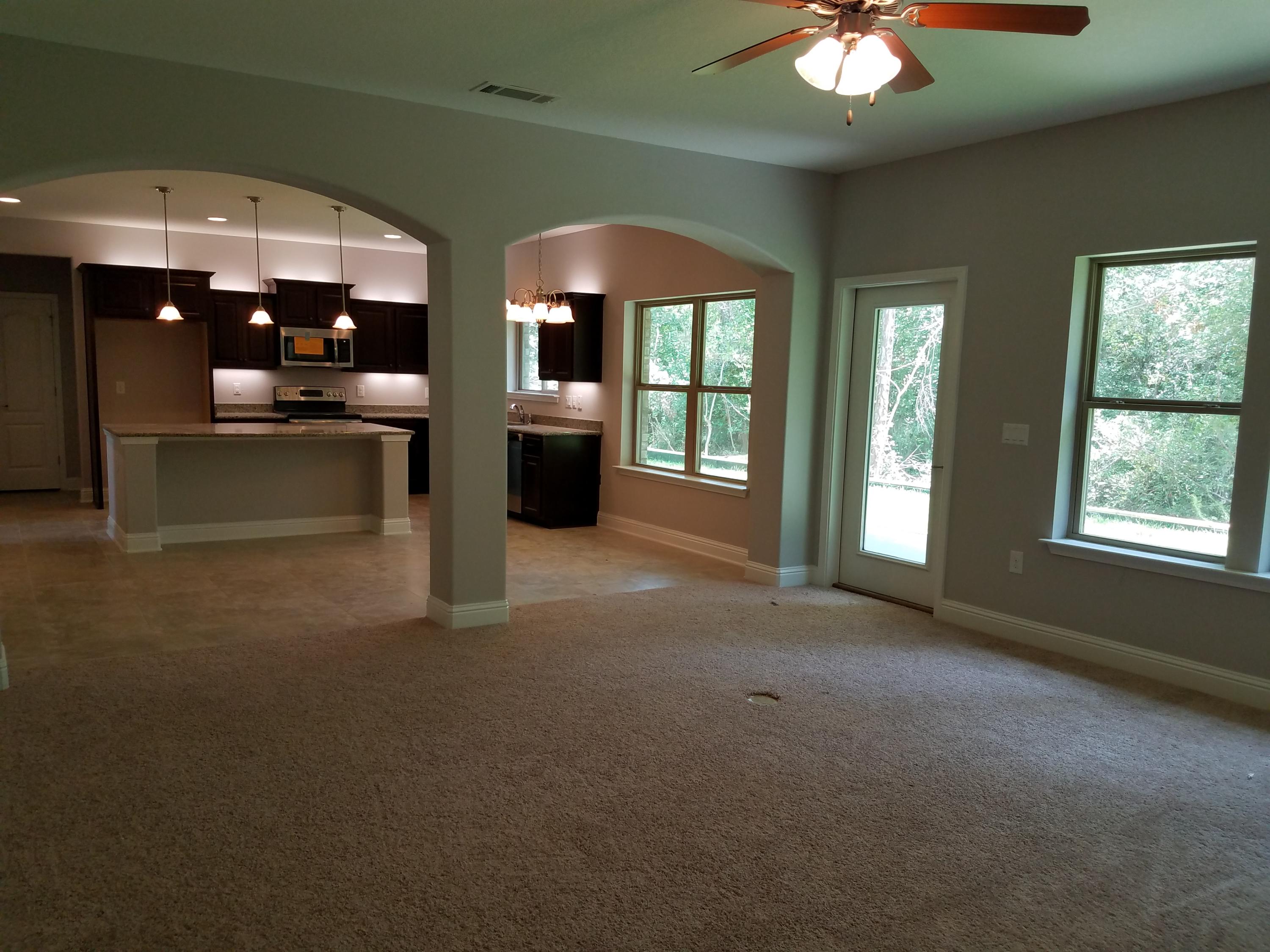7263 Riverview Road Navarre, FL 32566 - Photo 4 of 8 a view of lobby with furniture and chandelier fan