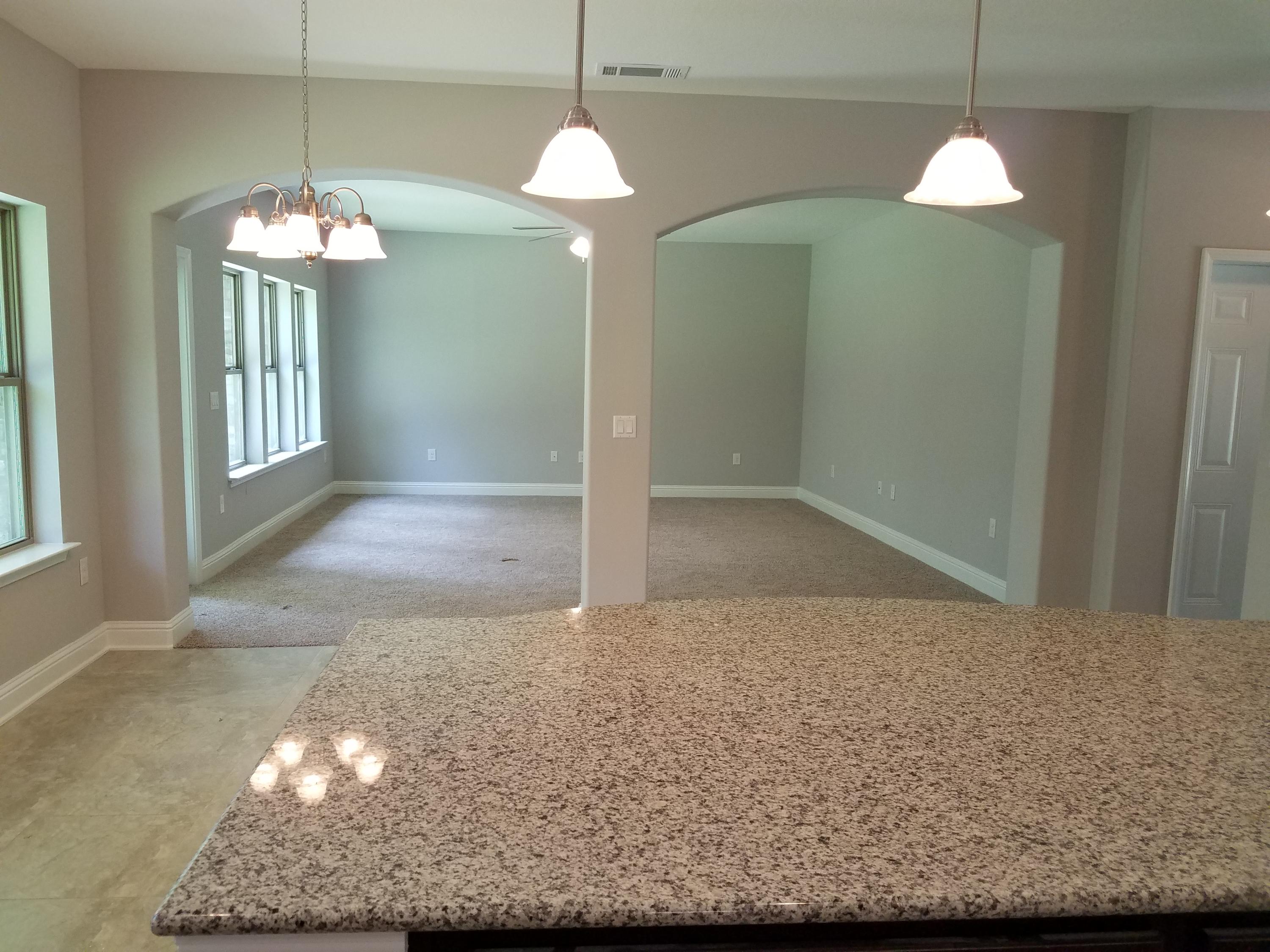 7263 Riverview Road Navarre, FL 32566 - Photo 6 of 8 a view of a livingroom with a chandelier wooden floor and a chandelier