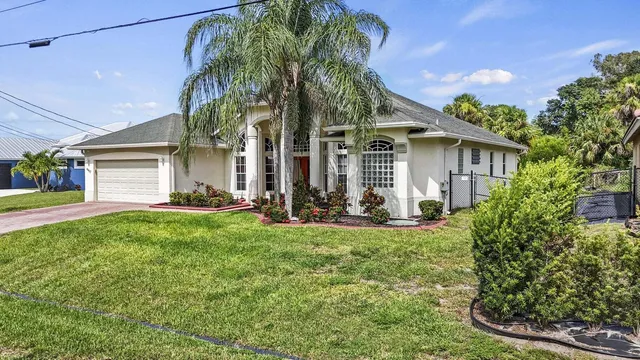 a view of a house with a yard and plants