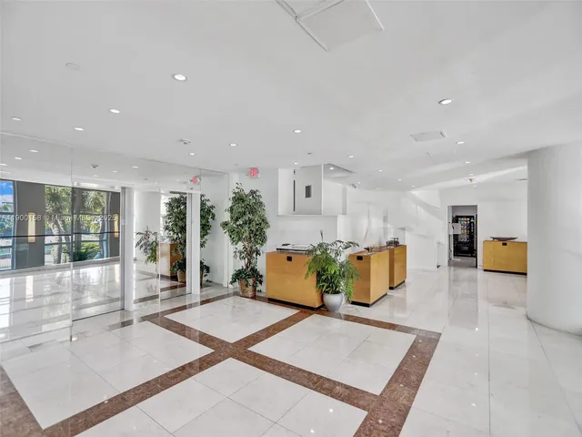 a kitchen with a dining table chairs and view of living room