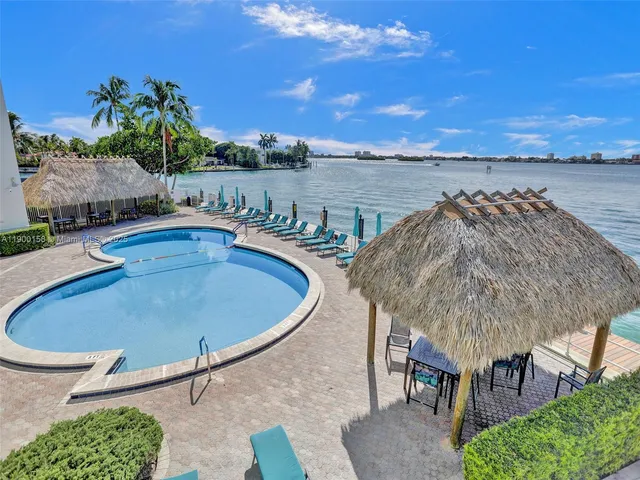 a wooden bench sitting in front of a building