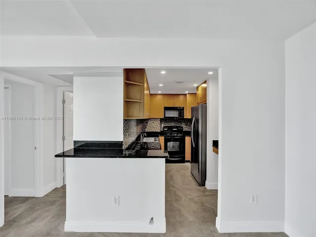 a kitchen with a refrigerator and a stove