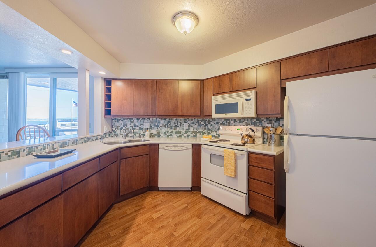 585 Hawthorne Street, Unit 103 Monterey, CA 93940 - Photo 13 of 30 a kitchen with stainless steel appliances granite countertop a sink stove and refrigerator