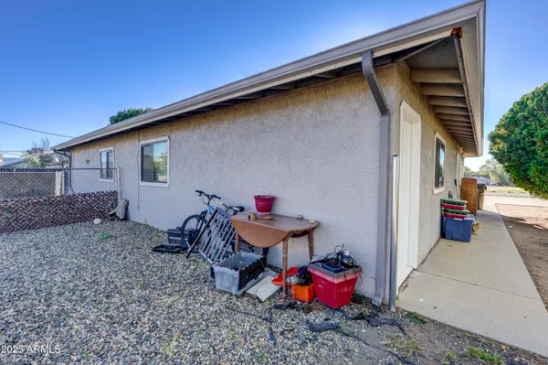a backyard of a house with table and chairs