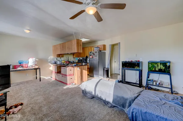 a bedroom with furniture and a flat screen tv