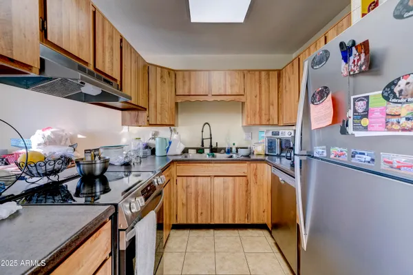 a kitchen with lots of counter top space and stainless steel appliances