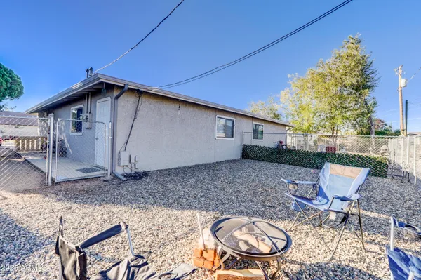 a backyard of a house with table and chairs
