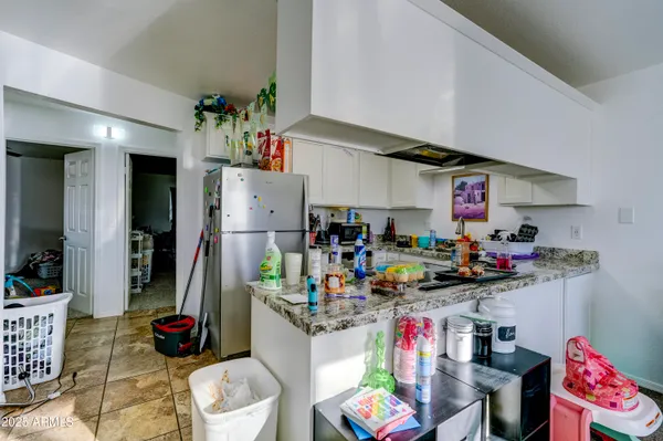 a kitchen with a refrigerator and dishwasher a stove top oven