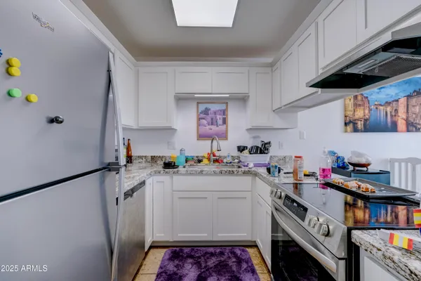 a kitchen with a sink a stove and cabinets