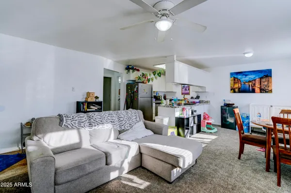 a living room with furniture and a chandelier