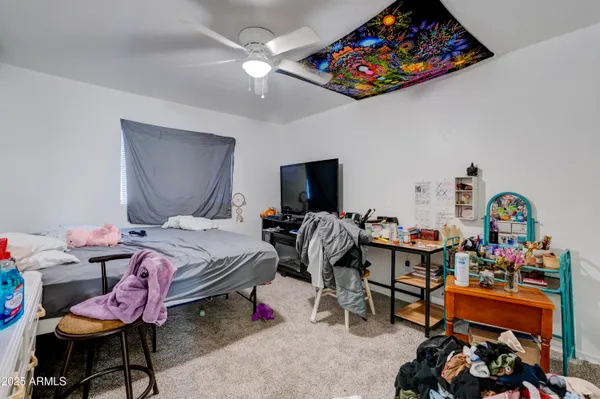 a bedroom with furniture and a flat screen tv