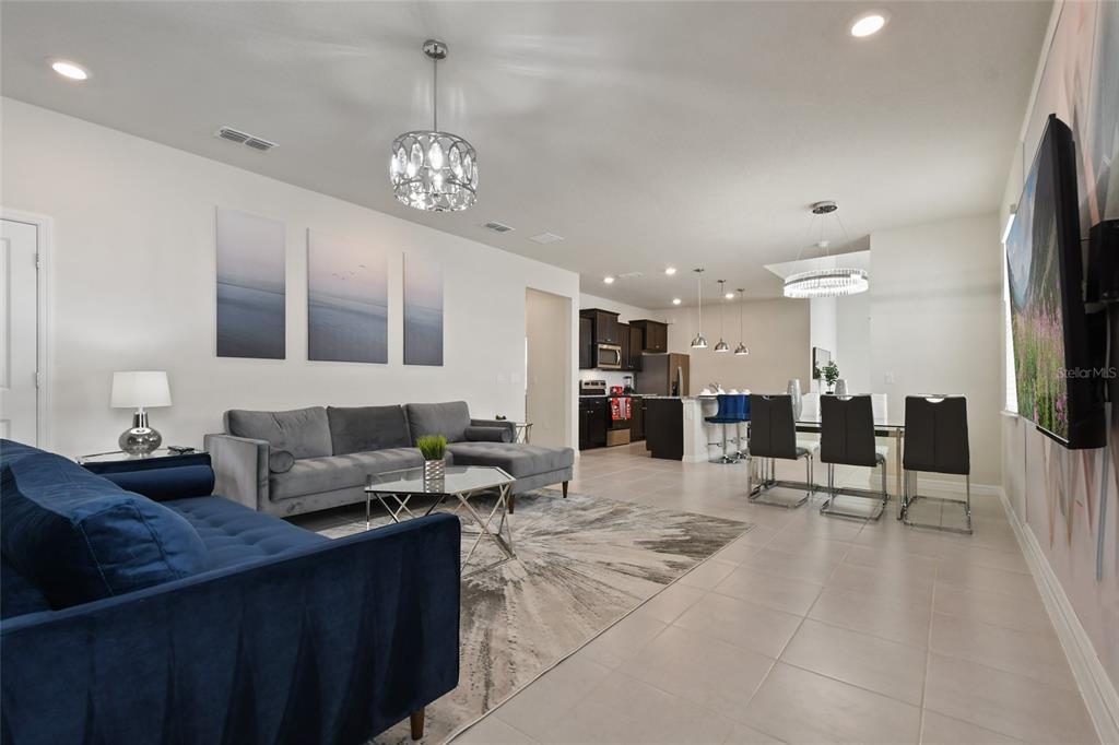 4428 Kaipo Road Davenport, FL 33897 - Photo 15 of 73 a kitchen with stainless steel appliances kitchen island granite countertop a sink and cabinets