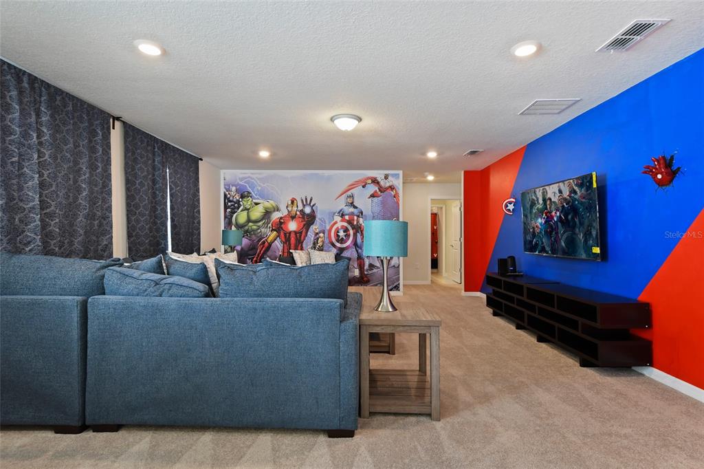 4428 Kaipo Road Davenport, FL 33897 - Photo 24 of 73 a living room with furniture and a flat screen tv