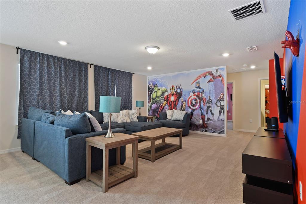 4428 Kaipo Road Davenport, FL 33897 - Photo 25 of 73 a living room with furniture and a flat screen tv