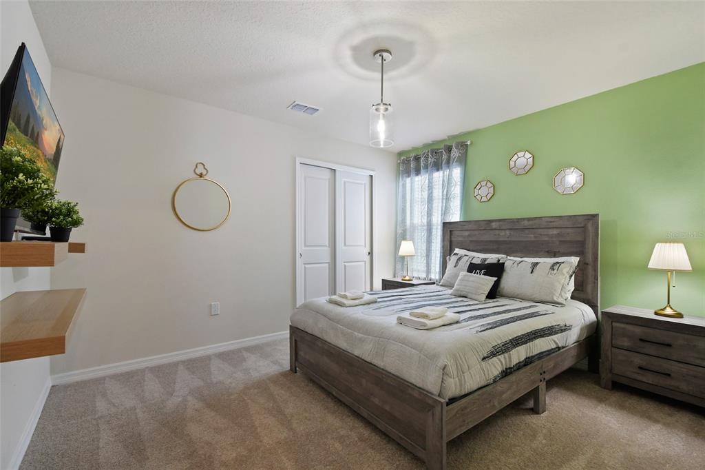 4428 Kaipo Road Davenport, FL 33897 - Photo 37 of 73 a bedroom with a bed chandelier and a window