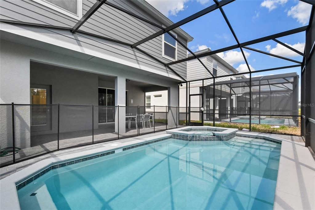 4428 Kaipo Road Davenport, FL 33897 - Photo 50 of 73 a swimming pool with large glass windows and painted walls