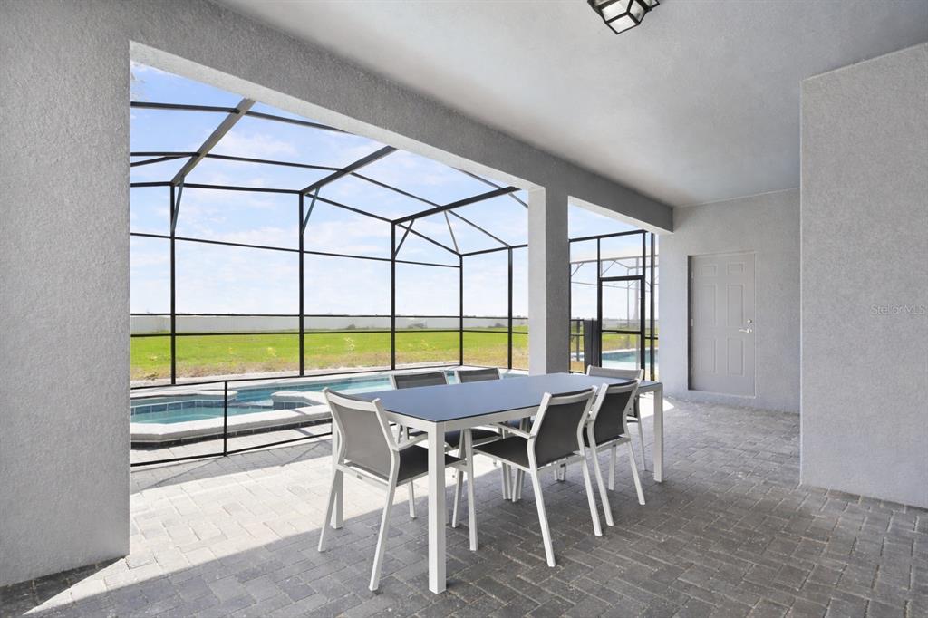 4428 Kaipo Road Davenport, FL 33897 - Photo 51 of 73 a view of a dining room with furniture window and outside view